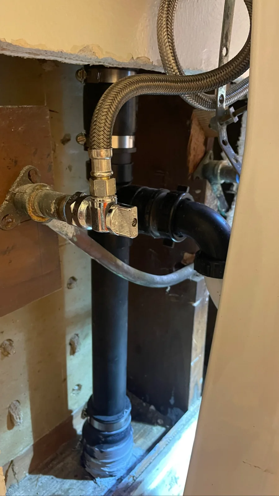 Sink plumbing connections installed inside an open wall